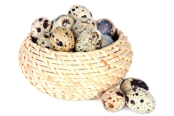 Quail eggs in wicker basket isolated on white — Stock Photo, Image