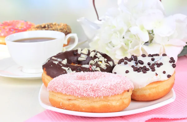 Sweet donuts with cup of tea on table close-up — Stock Photo, Image