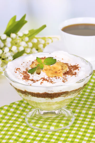 Delicious dessert with banana and caramel on table on light background — Stock Photo, Image