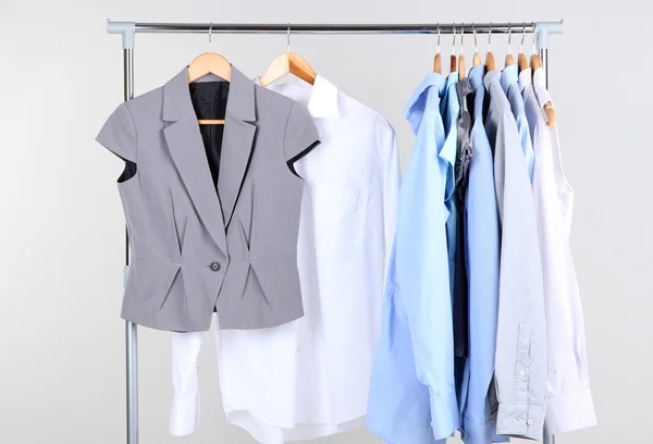 Office clothes on hangers, on gray background — Stock Photo, Image