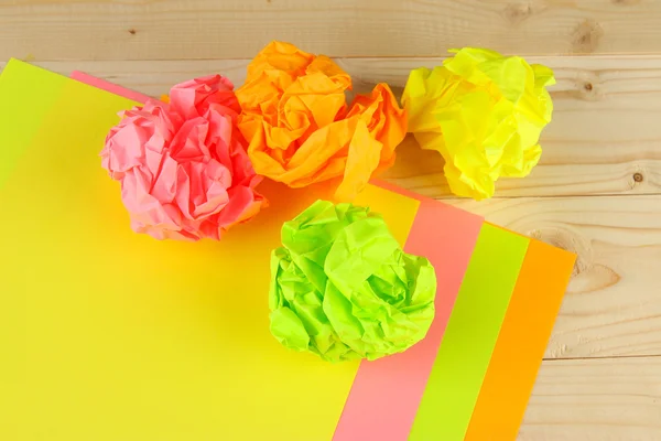 Colorful crumpled paper balls on wooden background — Stock Photo, Image