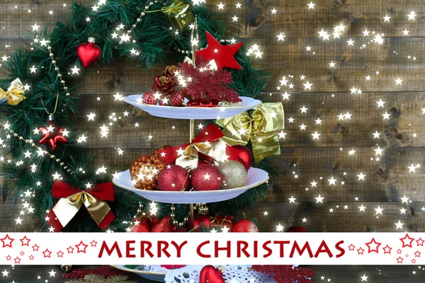 Christmas decorations on dessert stand, on wooden background — Stock Photo, Image