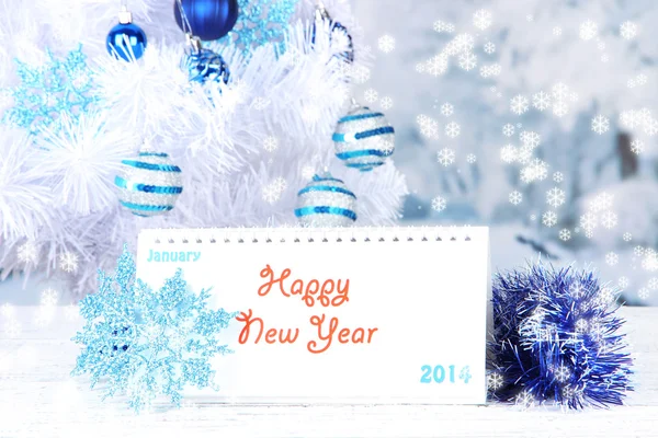 Calendar with New Year decorations on winter background — Stock Photo, Image