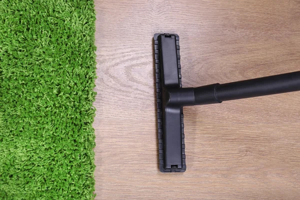 Vacuuming carpet in house — Stock Photo, Image