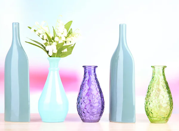 Different decorative vases on shelf on light background — Stock Photo, Image