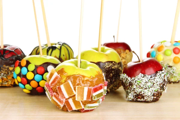 Candied apples on sticks on wooden table close up — Stock Photo, Image