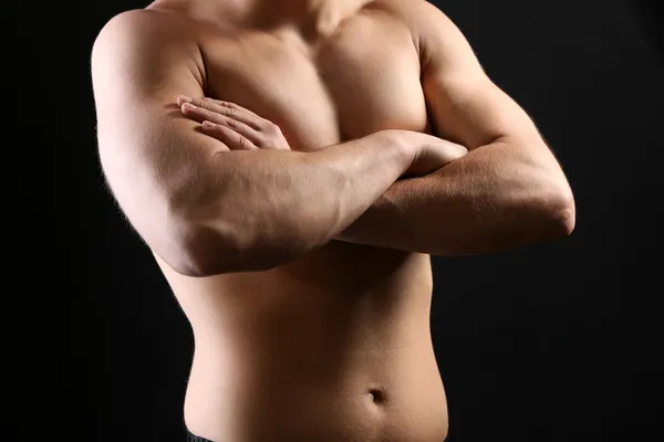 Handsome young muscular sportsman, on dark background — Stock Photo, Image