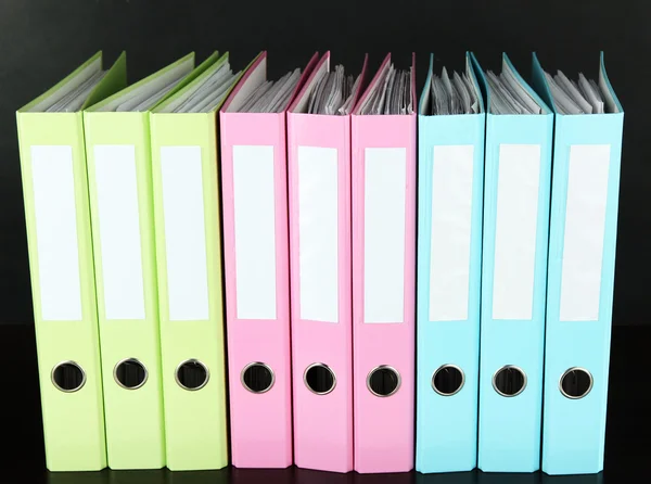 Colorful folders on wooden table, on grey background — Stock Photo, Image