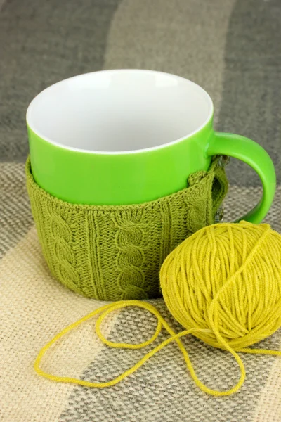 Cup with knitted thing on it close up — Stock Photo, Image