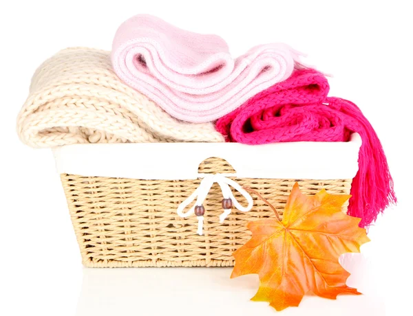 Warm knitted scarves in basket isolated on white — Stock Photo, Image