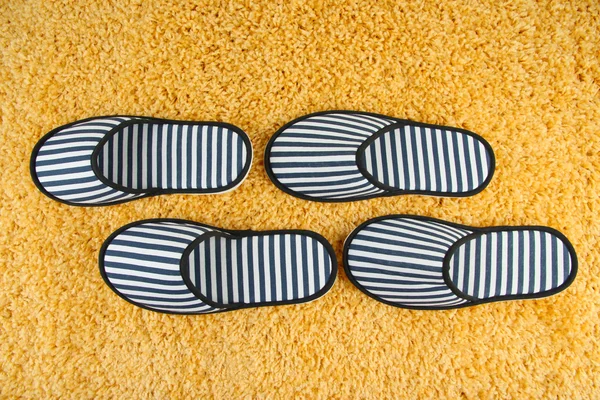 Striped slippers on carpet background — Stock Photo, Image