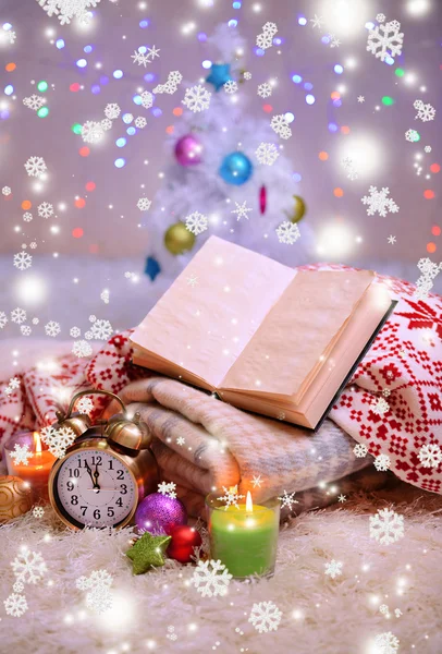 Composition with plaids, candles and Christmas decorations, on white carpet on bright background — Stock Photo, Image