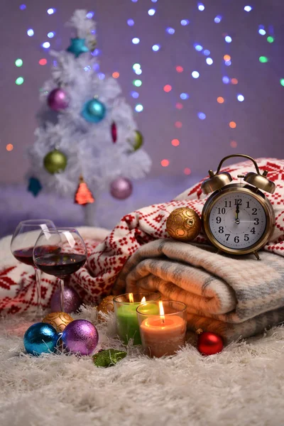 Composition with plaids, candles and Christmas decorations, on white carpet on bright background — Stock Photo, Image