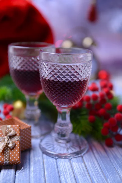 Wine glasses and Christmas decoration on bright background — Stock Photo, Image