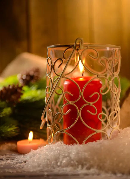 Candles and Christmas decoration on wooden background — Stock Photo, Image