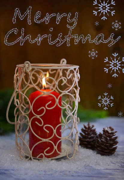 Candle and Christmas tree bud on wooden background — Stock Photo, Image