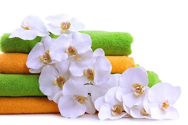 Colorful towels and orchid flowers, isolated on white — Stock Photo, Image