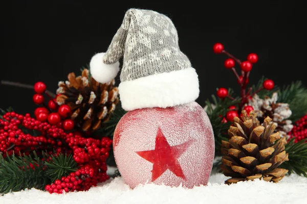 Holiday apple with frosted star in snow on black background — Stock Photo, Image