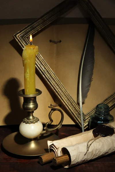 Old candle on table in room — Stock Photo, Image