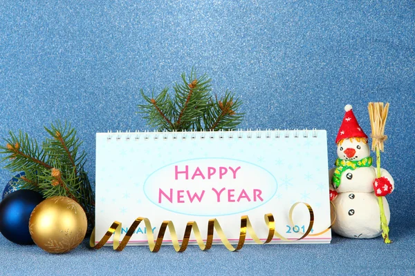 Calendar, New Year decor and fir tree on blue background — Stock Photo, Image