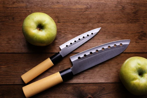 Kitchen knives on wooden background — Stock Photo, Image