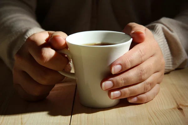 Le mani che tengono la tazza di bevanda calda, primo piano — Foto Stock