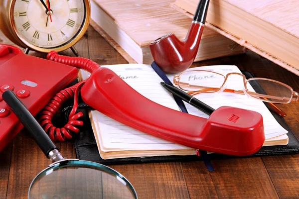 Telephone and notepad and other items, on wooden background — Stock Photo, Image