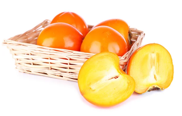 Ripe persimmons in wicker basket isolated on white — Stock Photo, Image