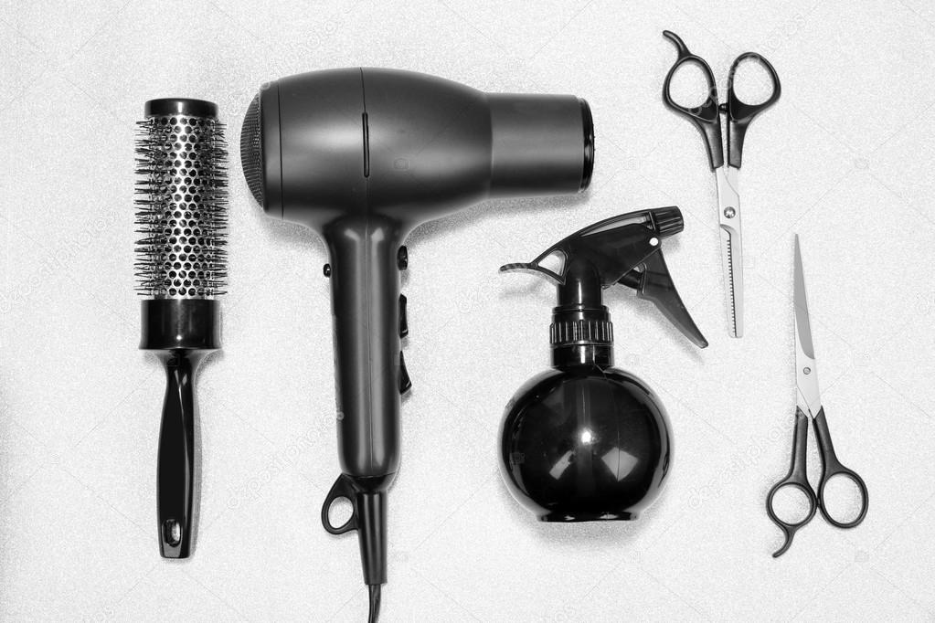 Hairdressing tools on silver background