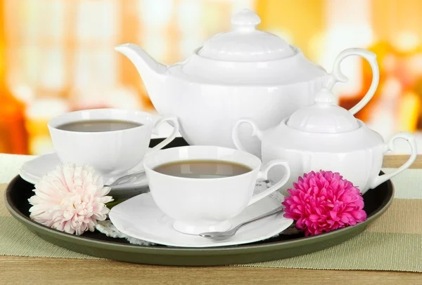 Cups of tea on tray on table in cafe — Stock Photo, Image