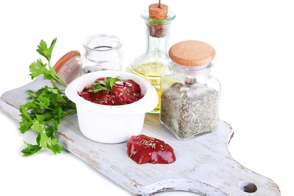 Raw liver in bowl with spices and condiments isolated on white — Stock Photo, Image