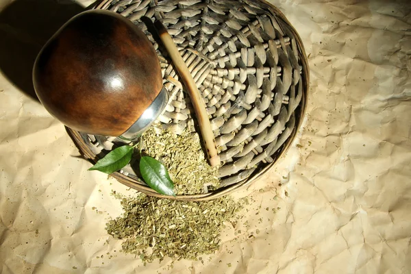 Calabash and bombilla with yerba mate on old paper background — Stock Photo, Image