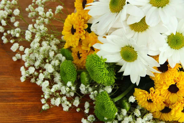 Beautiful flowers on wooden background — Stock Photo, Image