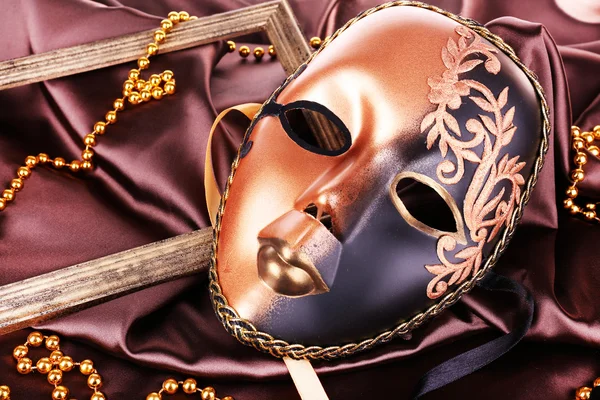 Mask on brown fabric background — Stock Photo, Image