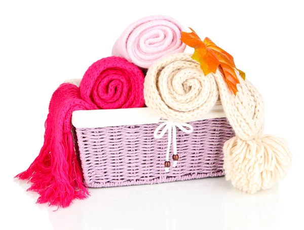 Warm knitted scarves in basket isolated on white — Stock Photo, Image