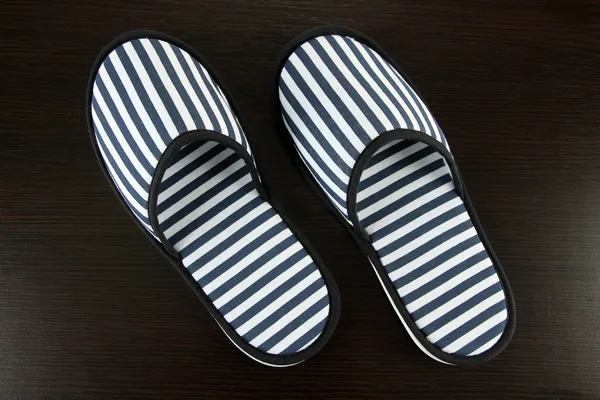 Striped slippers on wooden background — Stock Photo, Image