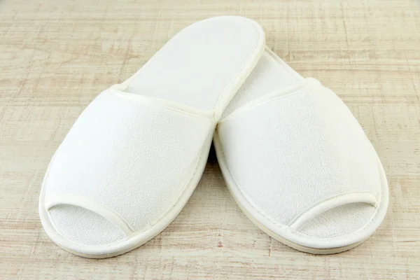 White slippers on wooden background — Stock Photo, Image