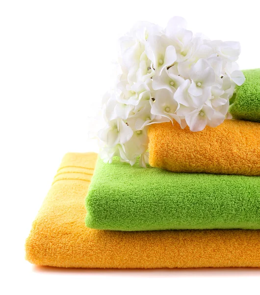 Colorful towels and flowers, isolated on white — Stock Photo, Image