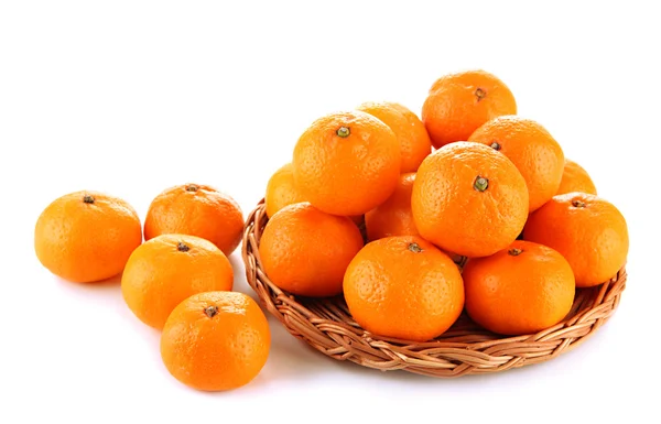 Ripe tangerines on wicker stand isolated on white — Stock Photo, Image