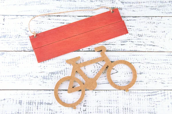 Decorative bicycle with plate on wooden background — Stock Photo, Image