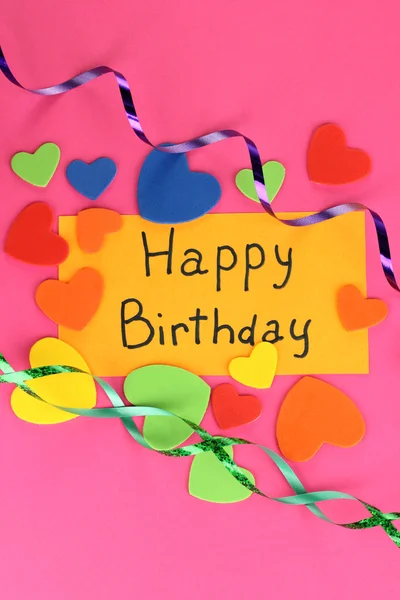 Karte "Happy Birthday" umgeben von festlichen Elementen auf rosa Hintergrund — Stockfoto
