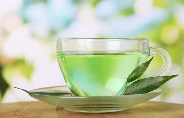 Transparent cup of green tea, on nature background — Stock Photo, Image