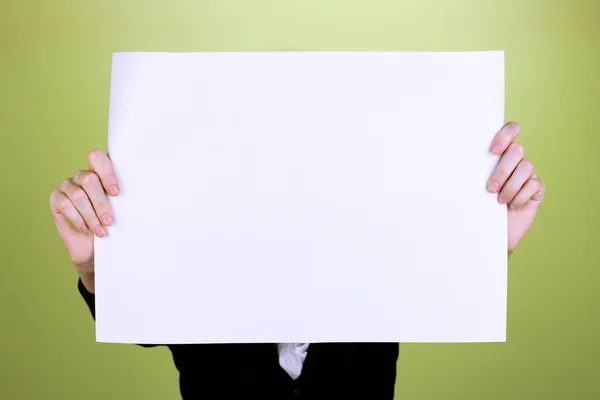 Woman holding blank sign in front her face, on color background — Stock Photo, Image