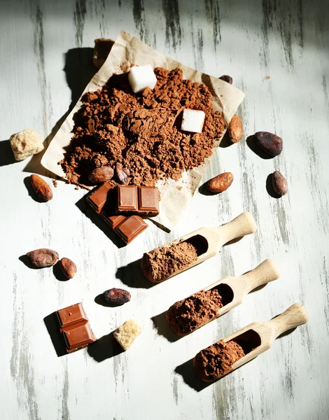 Cocoa powder on wooden table — Stock Photo, Image