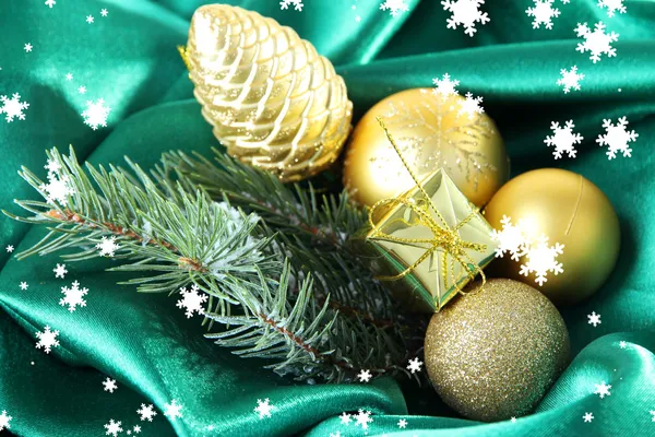 Beautiful Christmas decor on green satin cloth — Stock Photo, Image