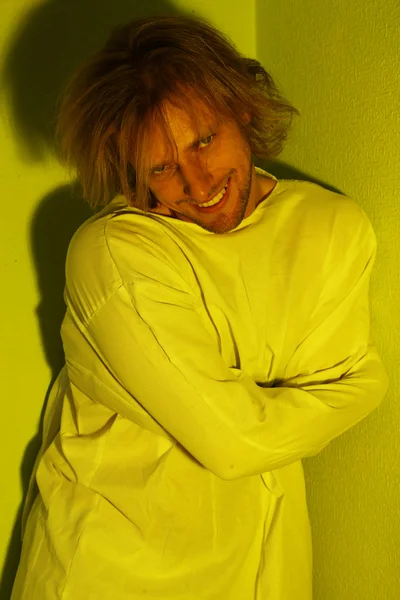 Mentally ill man in strait-jacket in room corner — Stock Photo, Image