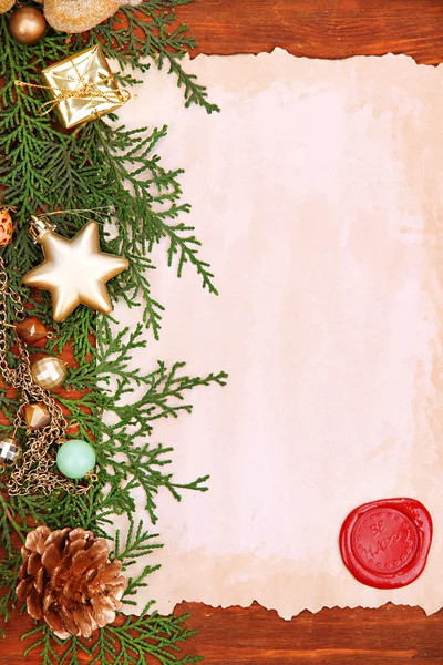 Frame with vintage paper and Christmas decorations on wooden background — Stock Photo, Image
