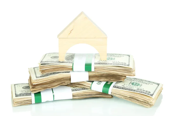 Wooden house on packs of dollars isolated on white — Stock Photo, Image