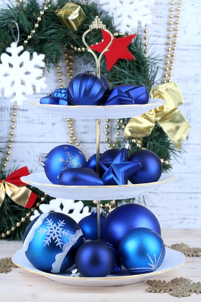 Weihnachtsdekoration auf Dessertständer, auf farbigem Holzhintergrund — Stockfoto