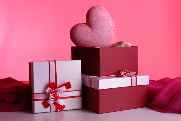 Bunt presentförpackning och dekorativt hjärta, på färgbakgrund — Stockfoto